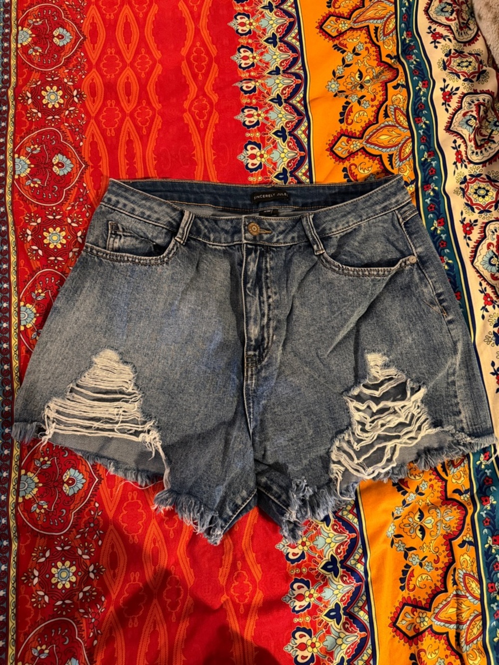 High-Rise Distressed Denim Shorts in Faded Blue